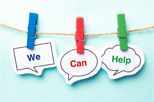 The words "We Can Help" in thought bubbles hanging from blue, red, and green clothespins a string.