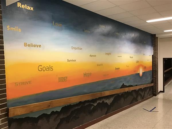 Sunset mural with positive messages like \